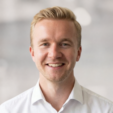 Porträt eines lächelnden Mannes in weißem Hemd, der als HR Controlling Berater bei HR Metrics für die Digitalisierung von HR Prozessen tätig ist.